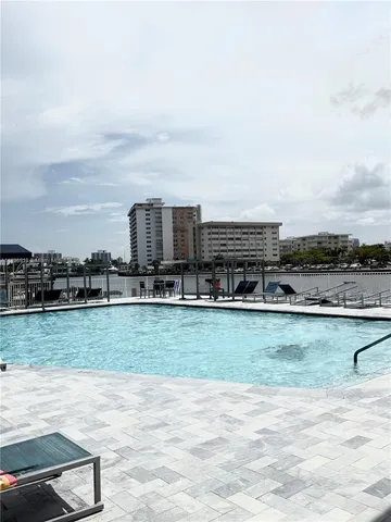 a view of a swimming pool with a yard