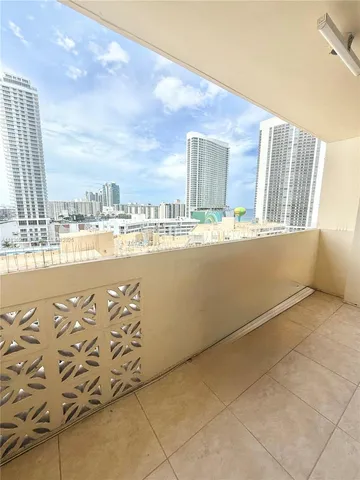 a living room with furniture a floor to ceiling window and a couch