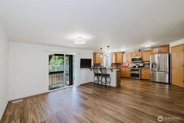 a view of kitchen with furniture and wooden floor