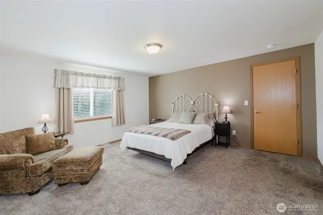 a spacious bedroom with a bed and a couch