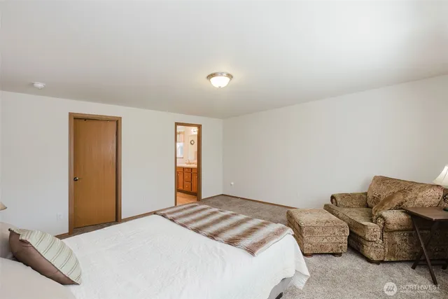 a bedroom with a bed and couch