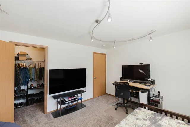 a view of a livingroom with furniture and a flat screen tv