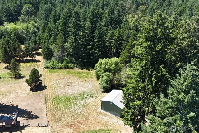 a view of a house with a yard and trees