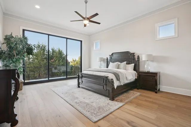 a bedroom with a large bed and a large window