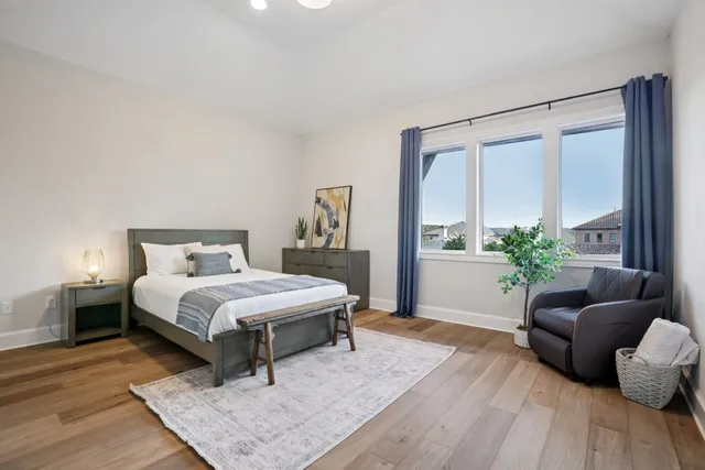 a bedroom with a bed and a couch