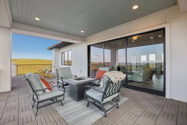 a balcony with furniture and a potted plant