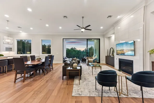 a living room with furniture flat screen tv and a large window