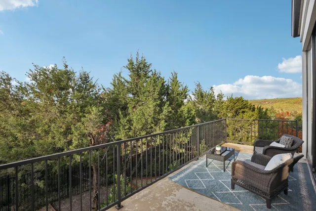 a view of a balcony with furniture