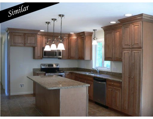 Lot 31 Tannery Road Sturbridge, MA 01518 - Photo 2 of 4 a kitchen with granite countertop a sink cabinets and wooden floor