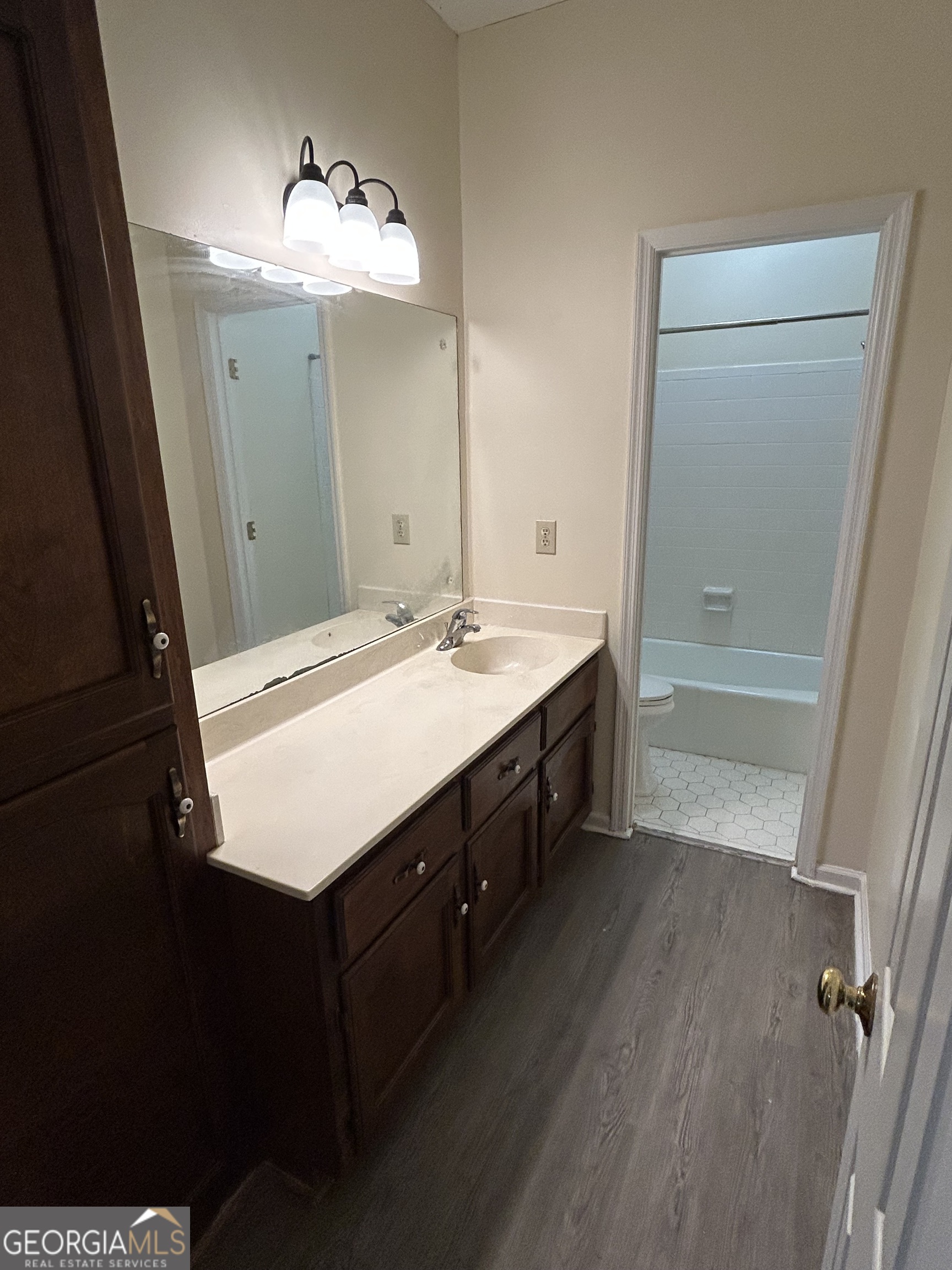 250 Cleveland Road, Unit 219 Bogart, GA 30622 - Photo 14 of 20 a bathroom with a double vanity sink a mirror and a bathtub
