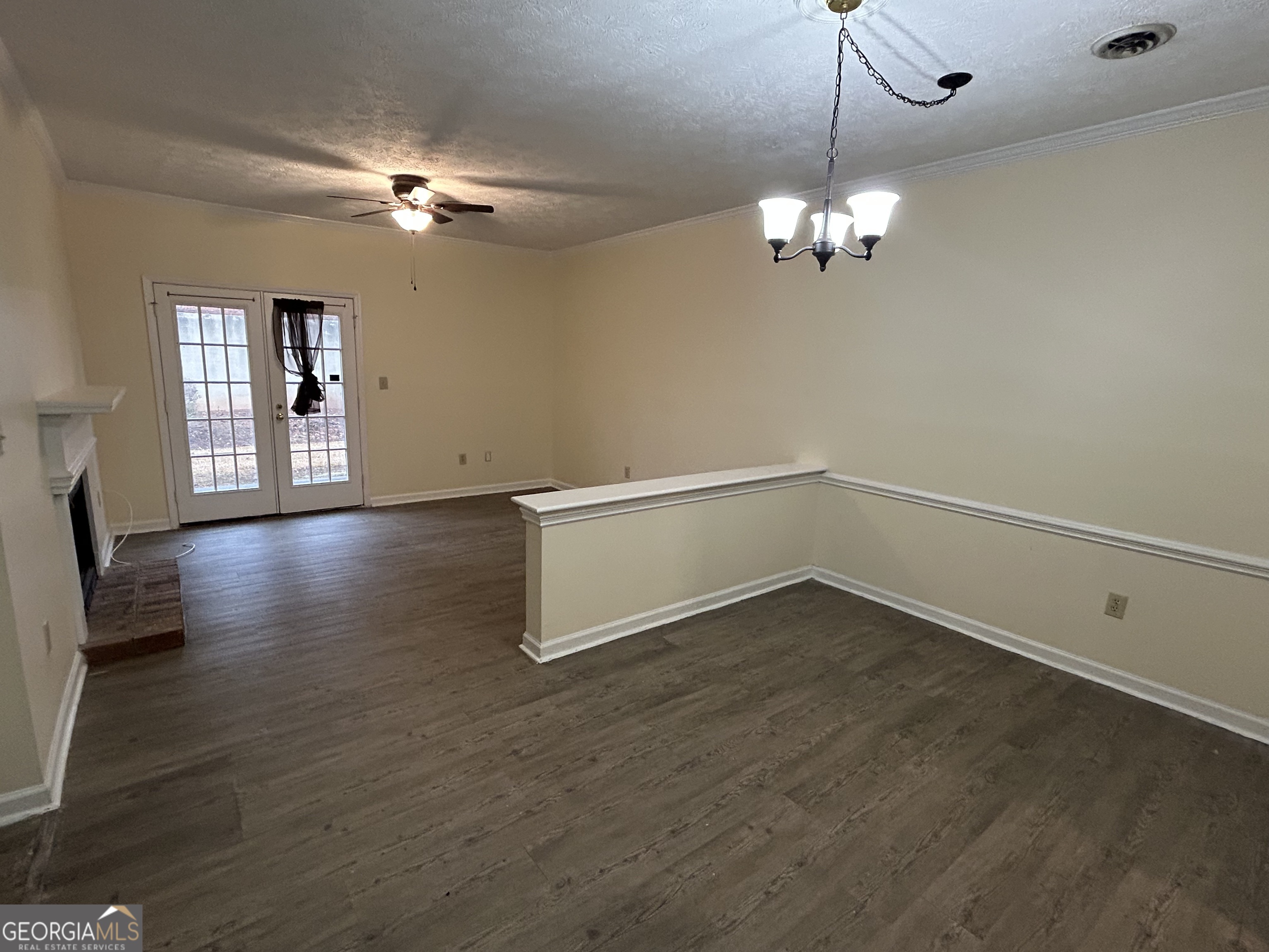 250 Cleveland Road, Unit 219 Bogart, GA 30622 - Photo 5 of 20 a view of an empty room with chandelier and wooden floor