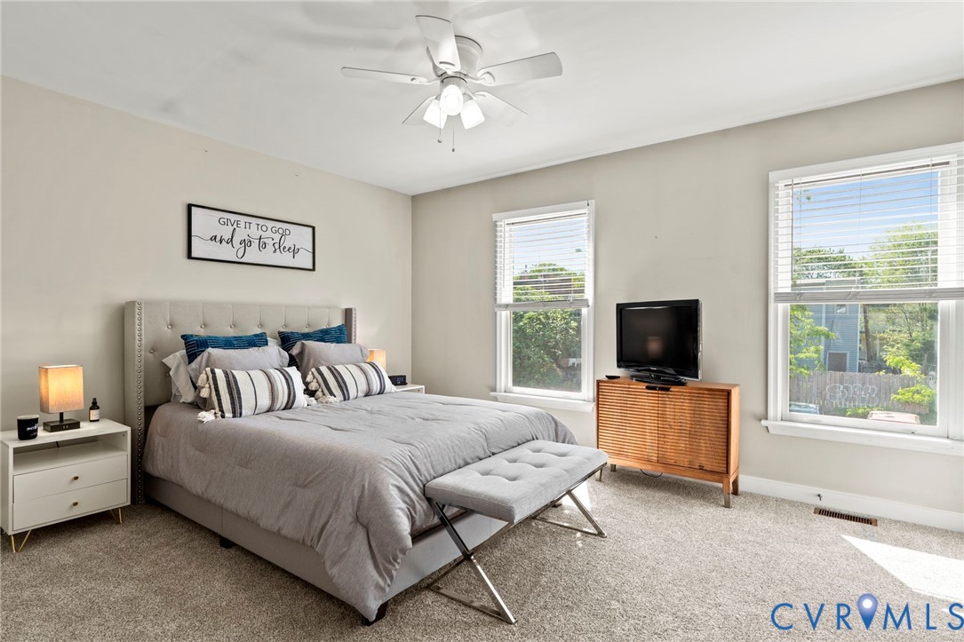 605 Spring Street, Unit B Richmond, VA 23220 - Photo 22 of 42 a bedroom with a bed and a flat screen tv