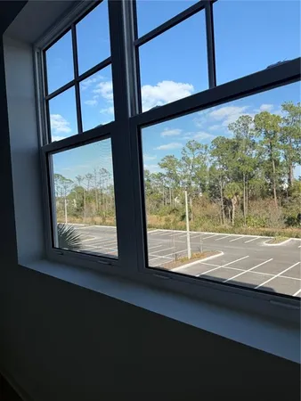 a view of a room with wooden floor and fence