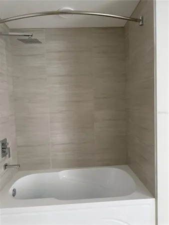 a bathroom with a shower and a sink