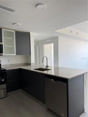 a kitchen with a sink and cabinets