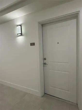 an empty room with closet and windows