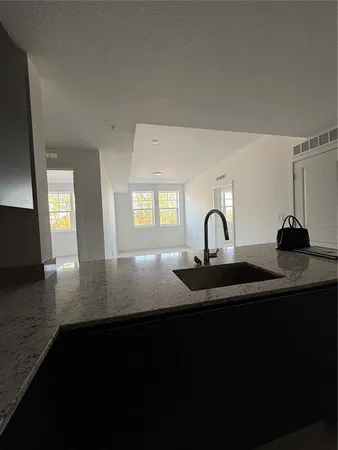 a view of dining room with kitchen sink and wooden floor