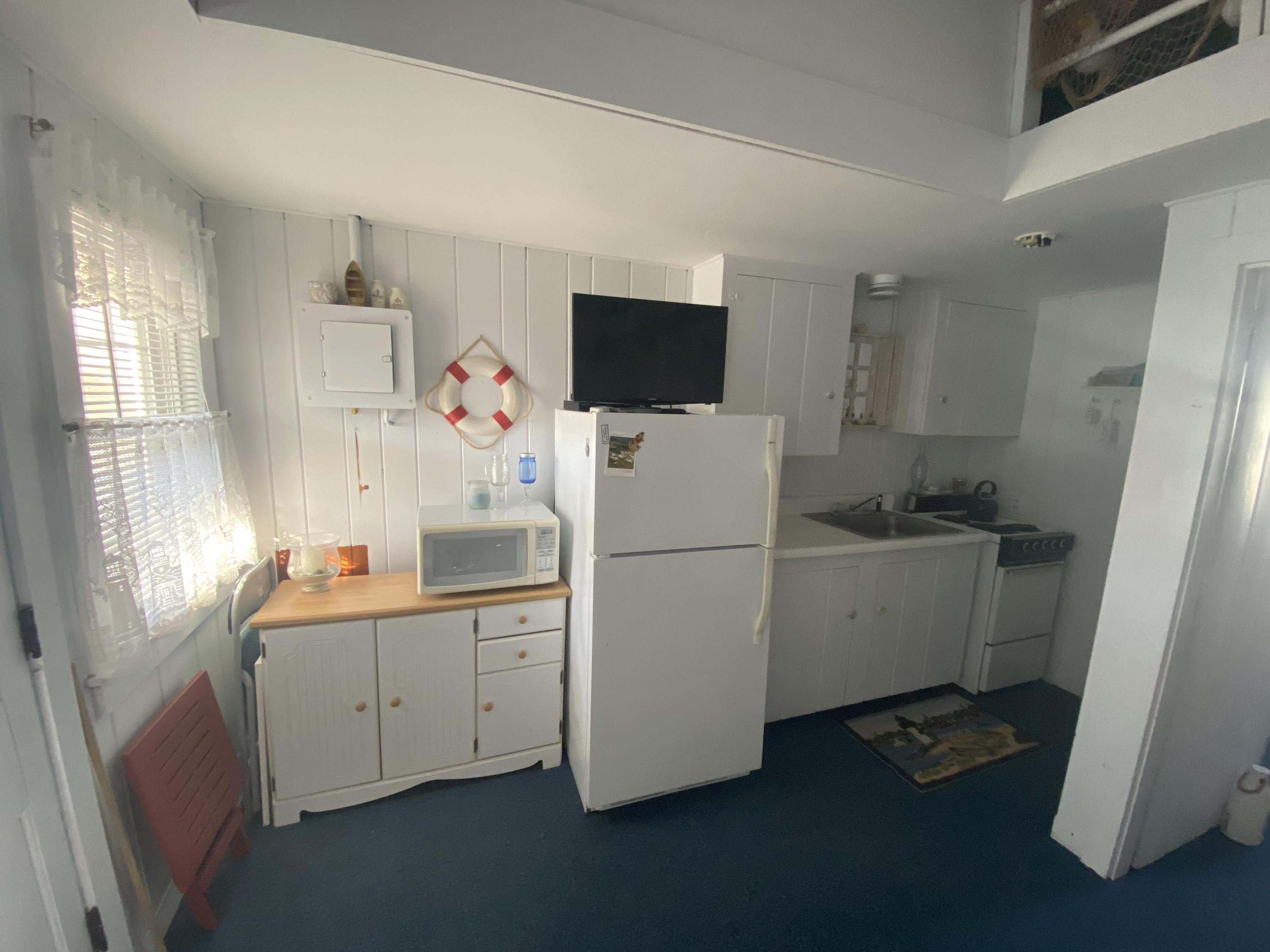 110 Glendon Road, Unit 8 Dennis Port, MA 02639 - Photo 11 of 21 a room with a refrigerator and a window