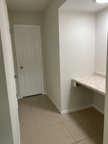 an empty room with kitchen