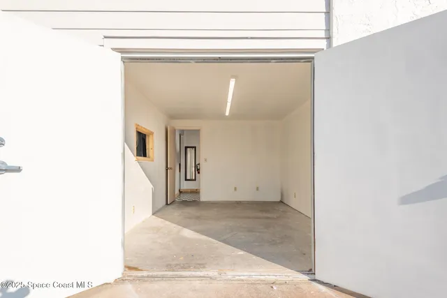 a view of a hallway with wooden floor and entryway