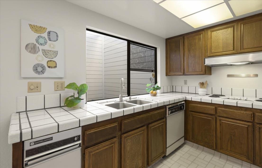 100 Strathmore Place Los Gatos, CA 95032 - Photo 13 of 39 a kitchen with a sink stove and cabinets