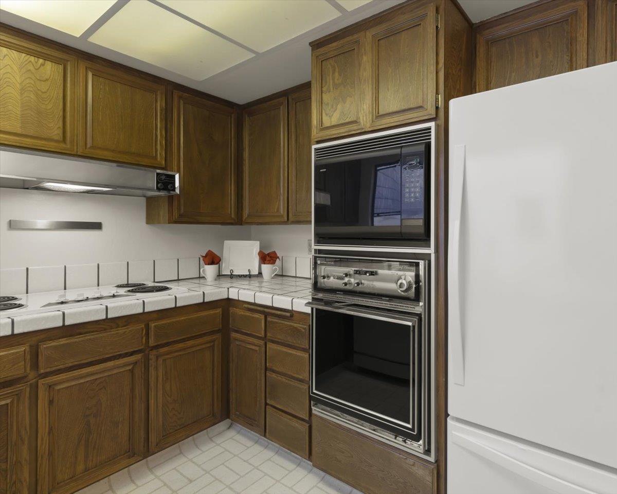 100 Strathmore Place Los Gatos, CA 95032 - Photo 15 of 39 a kitchen with stainless steel appliances granite countertop a stove and a microwave
