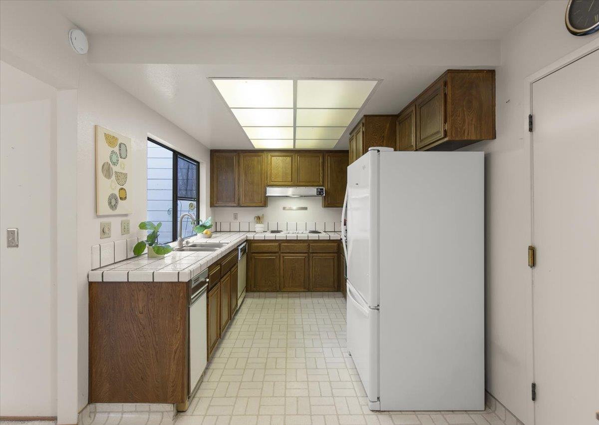 100 Strathmore Place Los Gatos, CA 95032 - Photo 17 of 39 a kitchen with stainless steel appliances granite countertop a refrigerator and a sink