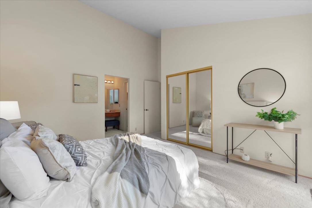 100 Strathmore Place Los Gatos, CA 95032 - Photo 19 of 39 a bedroom with a bed a mirror and a chandelier