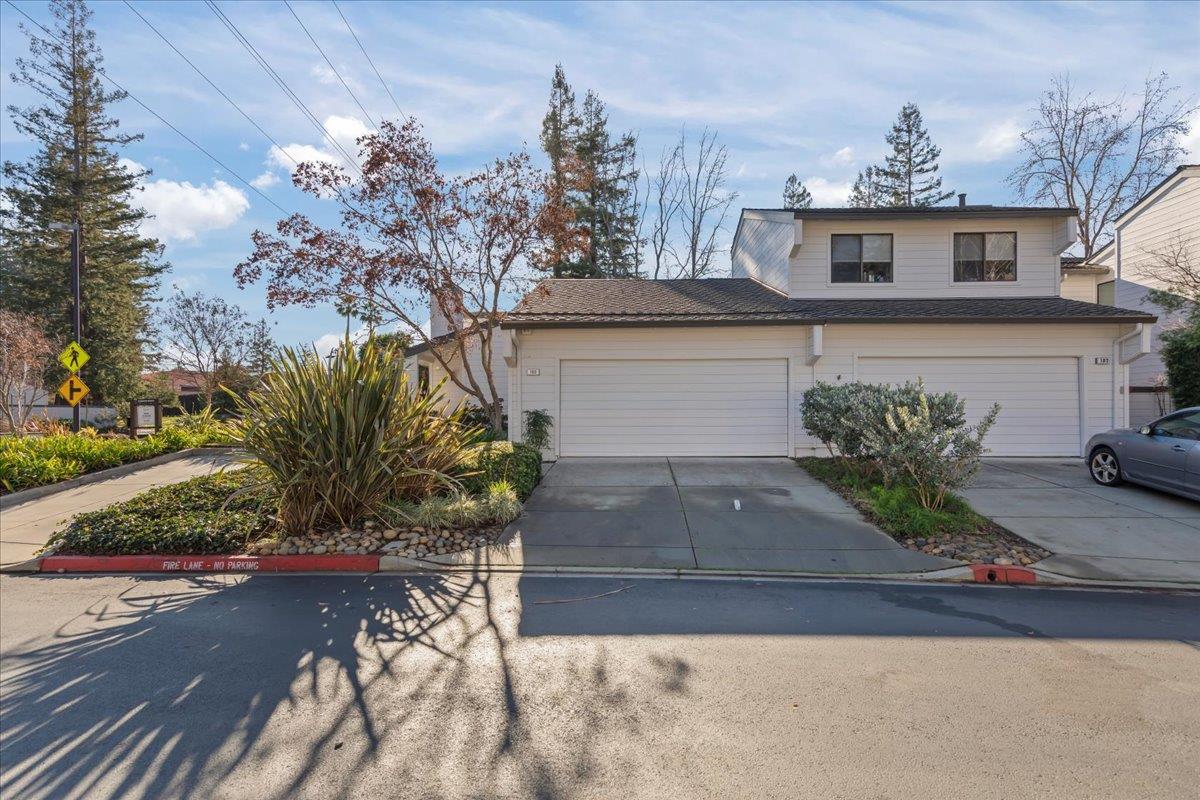 100 Strathmore Place Los Gatos, CA 95032 - Photo 2 of 39 a front view of a house with a yard and garage