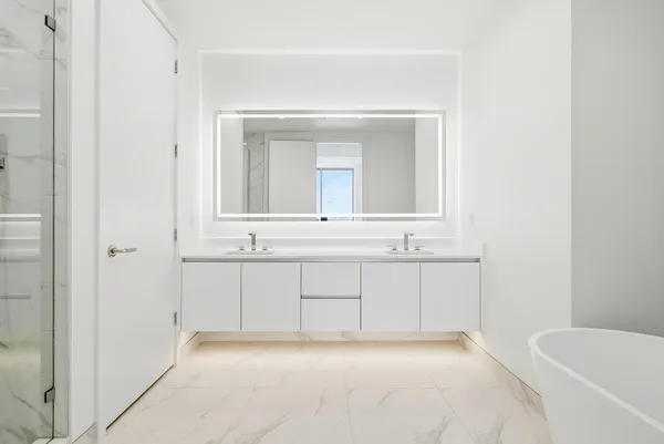 a living room with furniture kitchen view and large windows