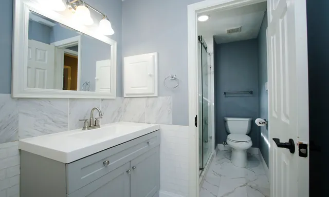 a bathroom with a sink toilet and shower