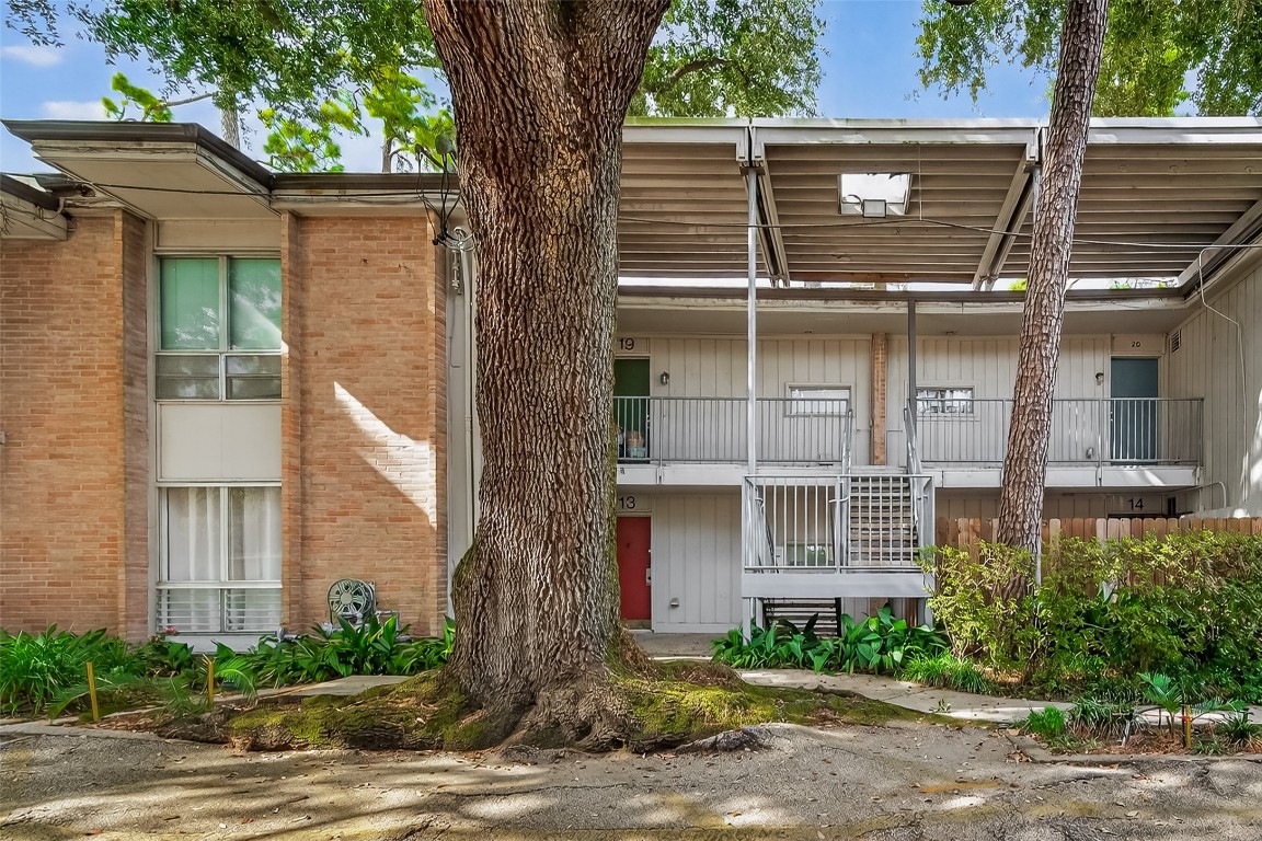 8211 Katy Freeway, Unit 19 Houston, TX 77024 - Photo 1 of 39 a front view of a house with garden
