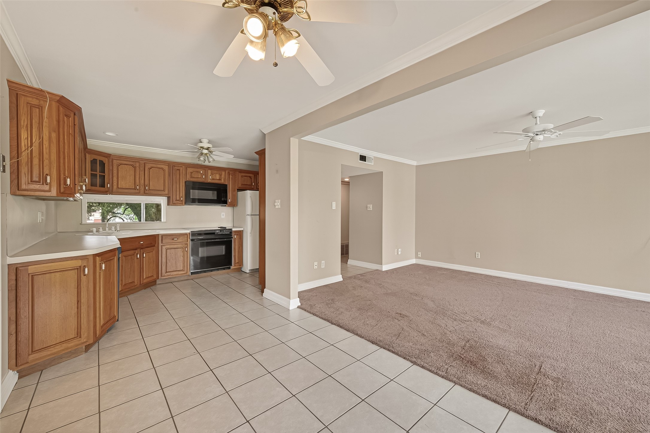 8211 Katy Freeway, Unit 19 Houston, TX 77024 - Photo 11 of 39 a large kitchen with cabinets and stainless steel appliances
