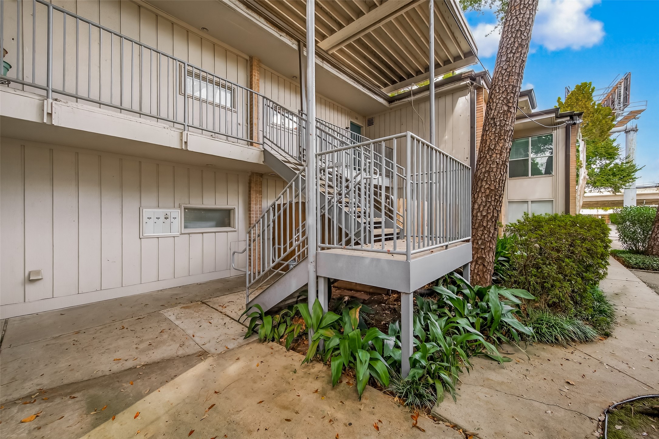 8211 Katy Freeway, Unit 19 Houston, TX 77024 - Photo 2 of 39 a view of a chair and table in the back yard