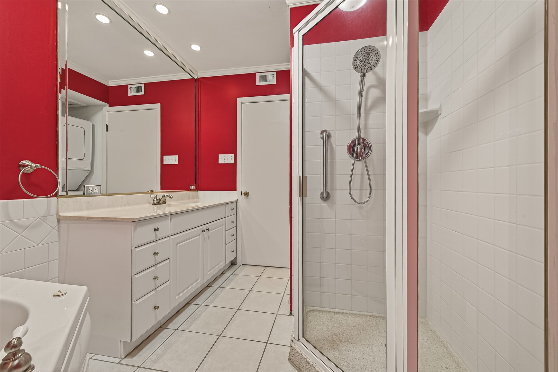 8211 Katy Freeway, Unit 19 Houston, TX 77024 - Photo 25 of 39 a bathroom with a shower sink and mirror