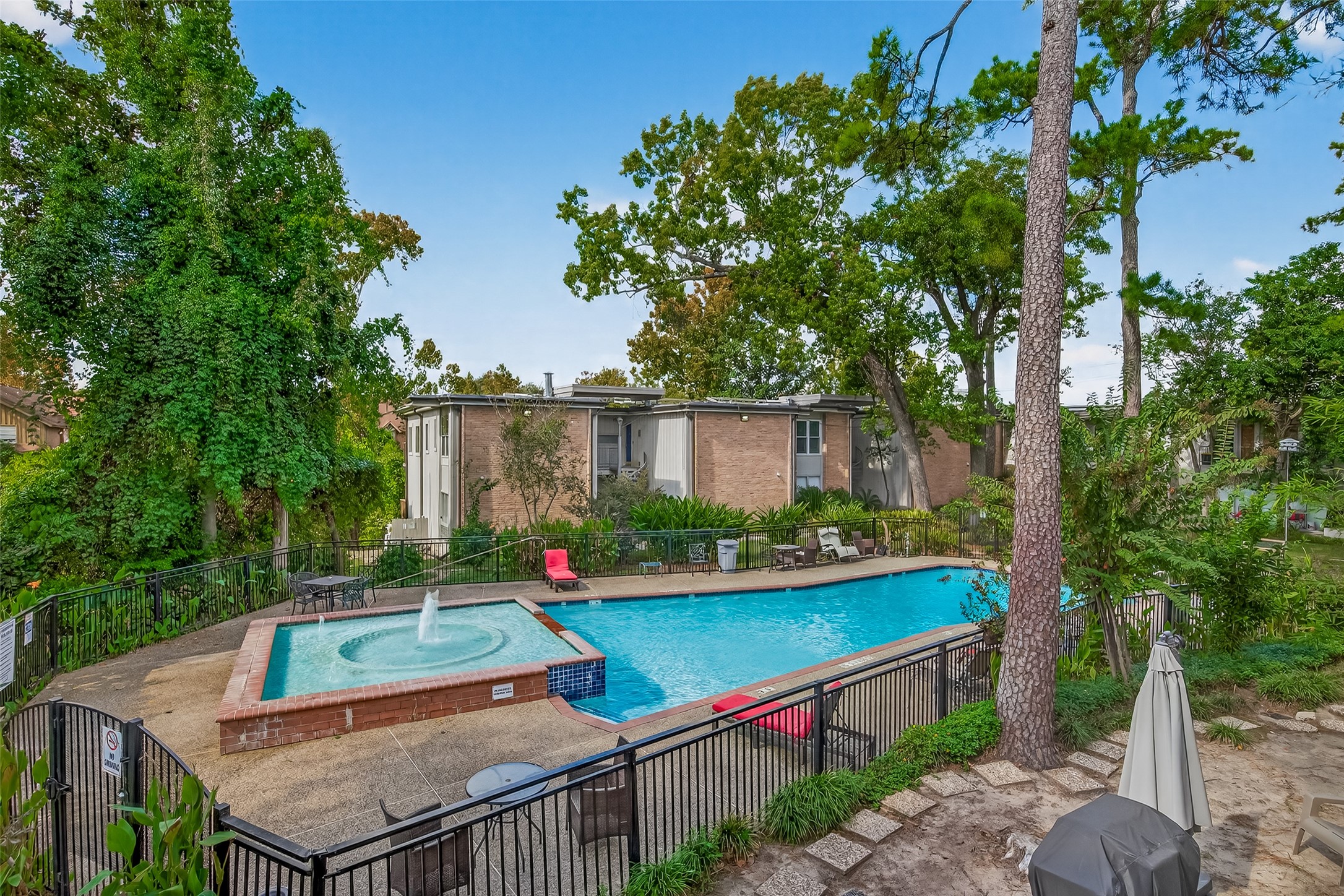 8211 Katy Freeway, Unit 19 Houston, TX 77024 - Photo 28 of 39 a view of a chairs and table on the deck
