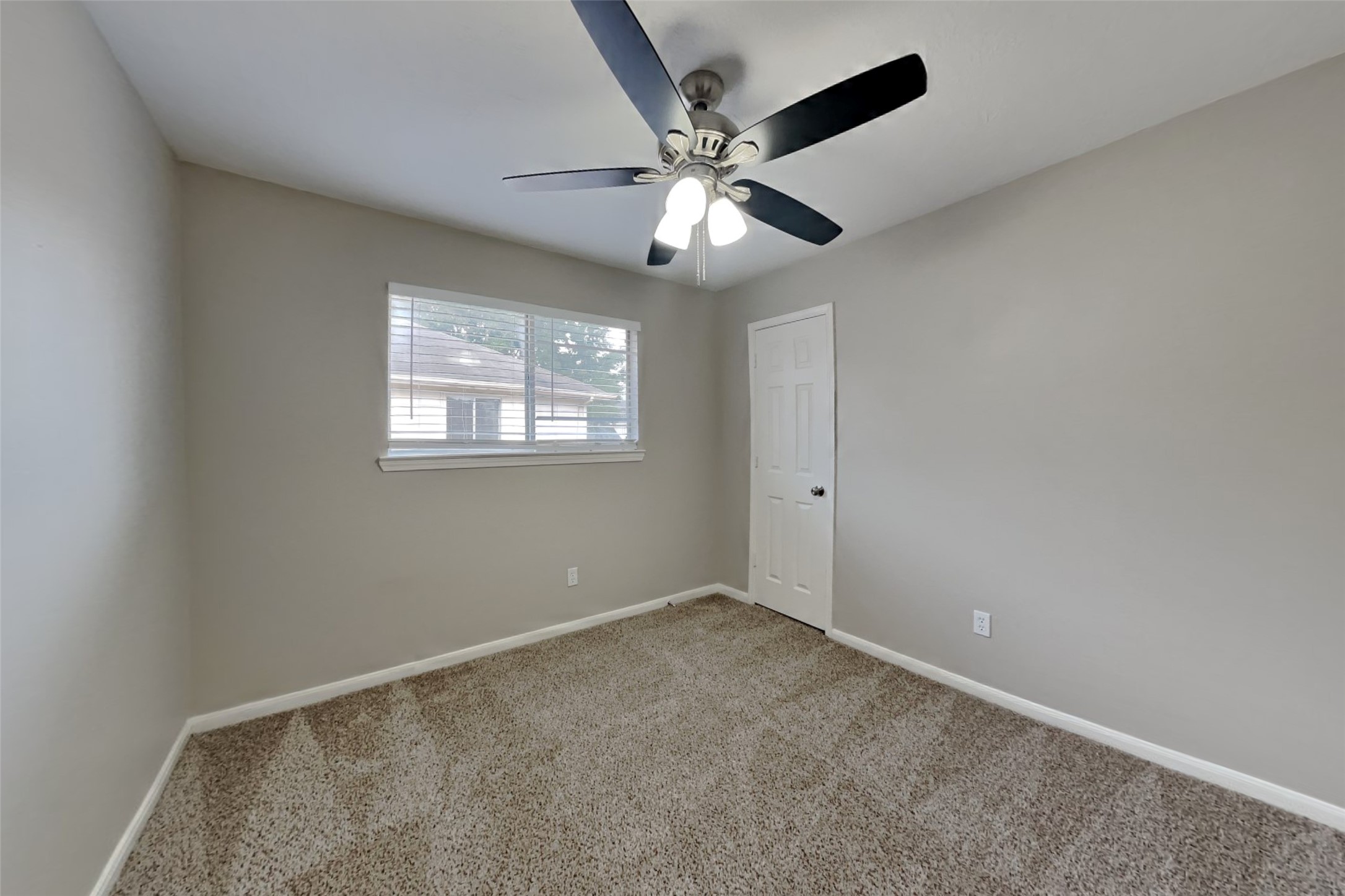 14706 Trailbrook Drive Houston, TX 77095 - Photo 11 of 23 an empty room with windows and fan