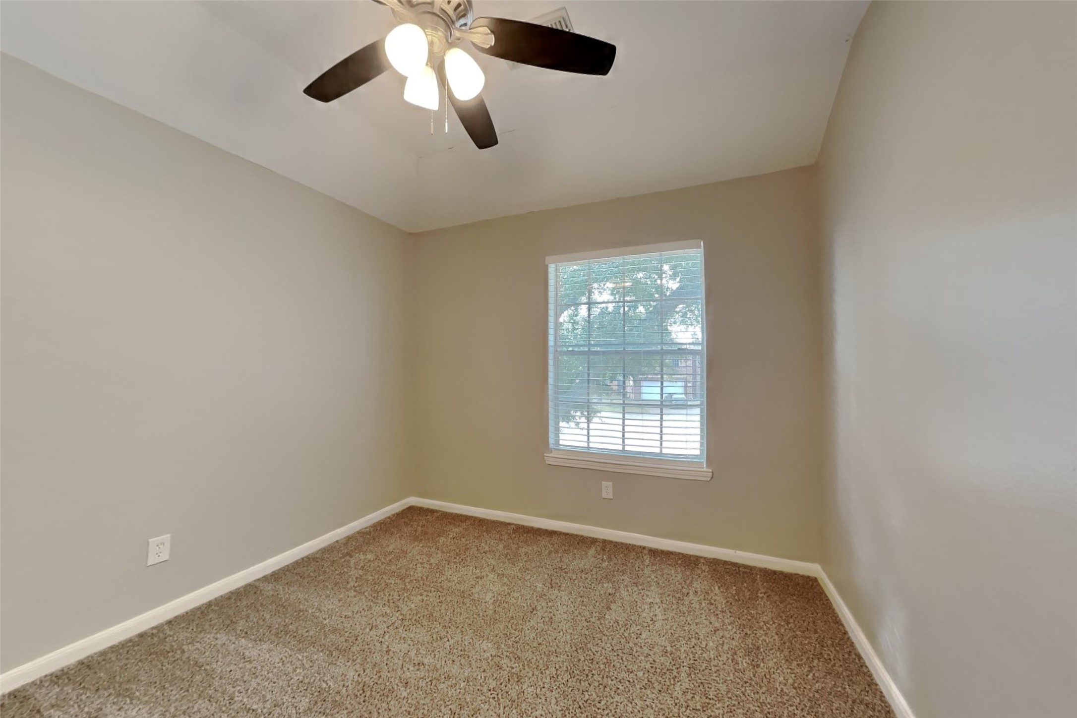 14706 Trailbrook Drive Houston, TX 77095 - Photo 15 of 23 an empty room with a window and a fan