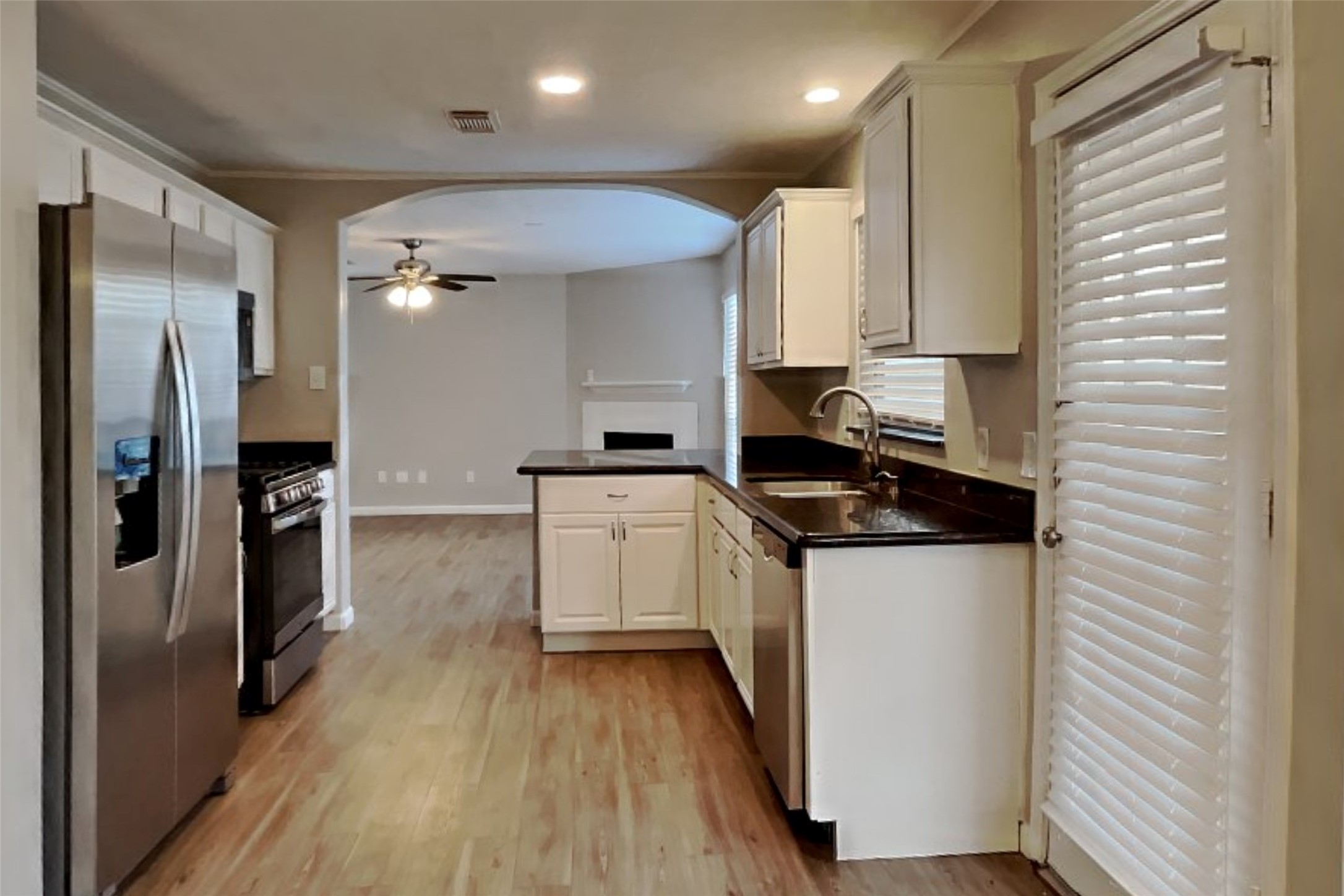 14706 Trailbrook Drive Houston, TX 77095 - Photo 4 of 23 a kitchen with stainless steel appliances a sink stove and refrigerator