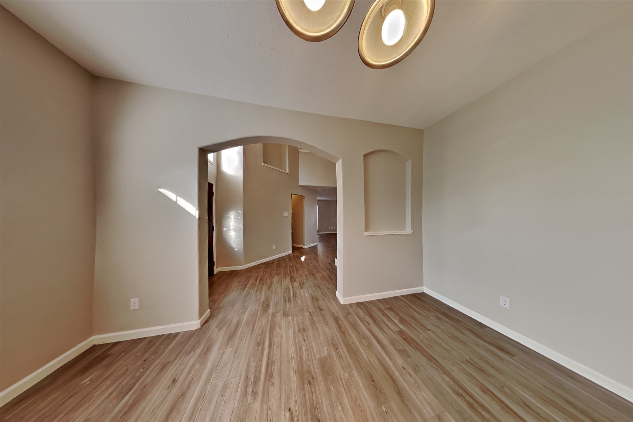 14706 Trailbrook Drive Houston, TX 77095 - Photo 5 of 23 a view of an empty room with wooden floor and a window