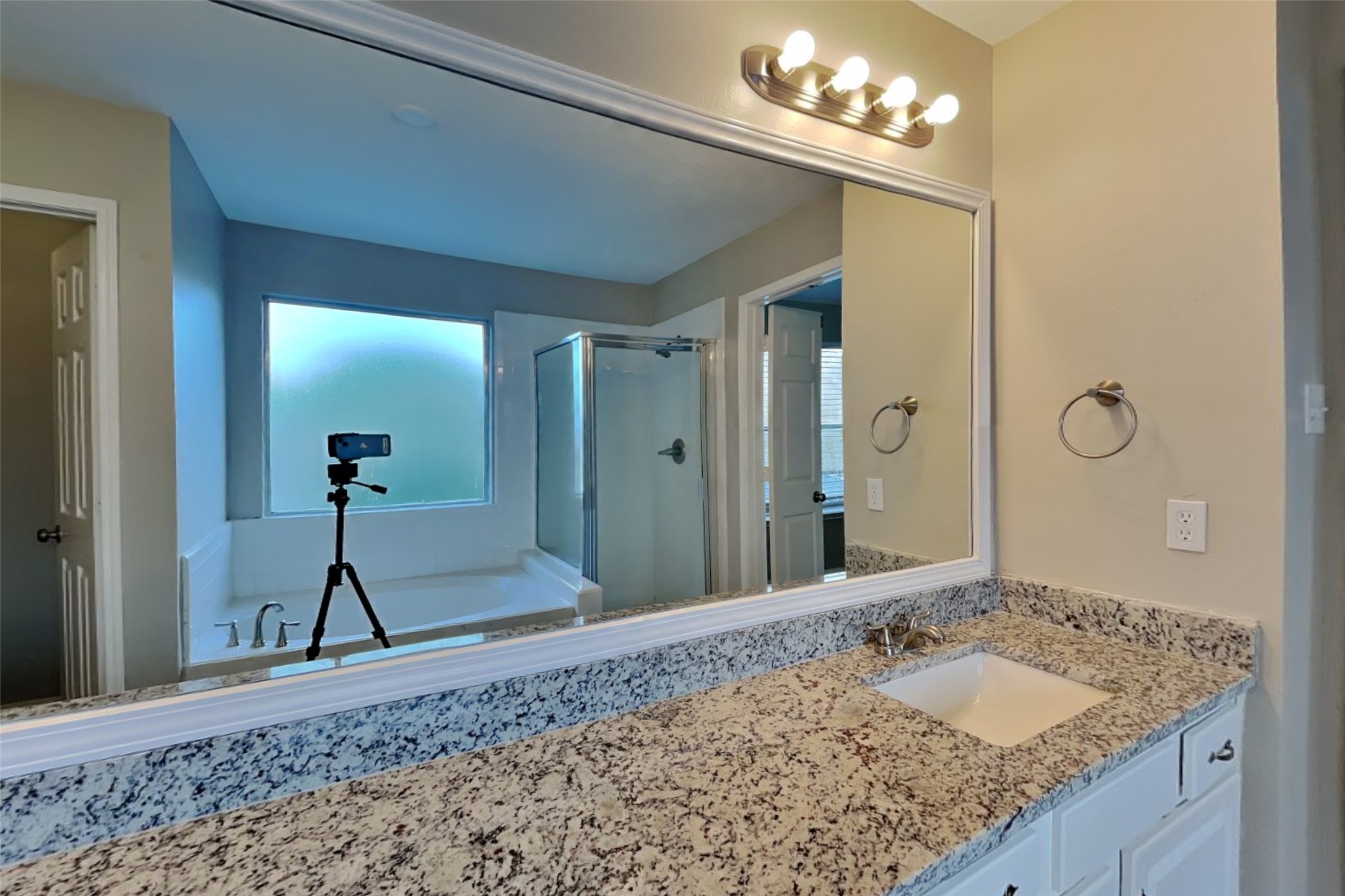 14706 Trailbrook Drive Houston, TX 77095 - Photo 10 of 23 a en suite bathroom with a granite countertop sink a mirror and a shower