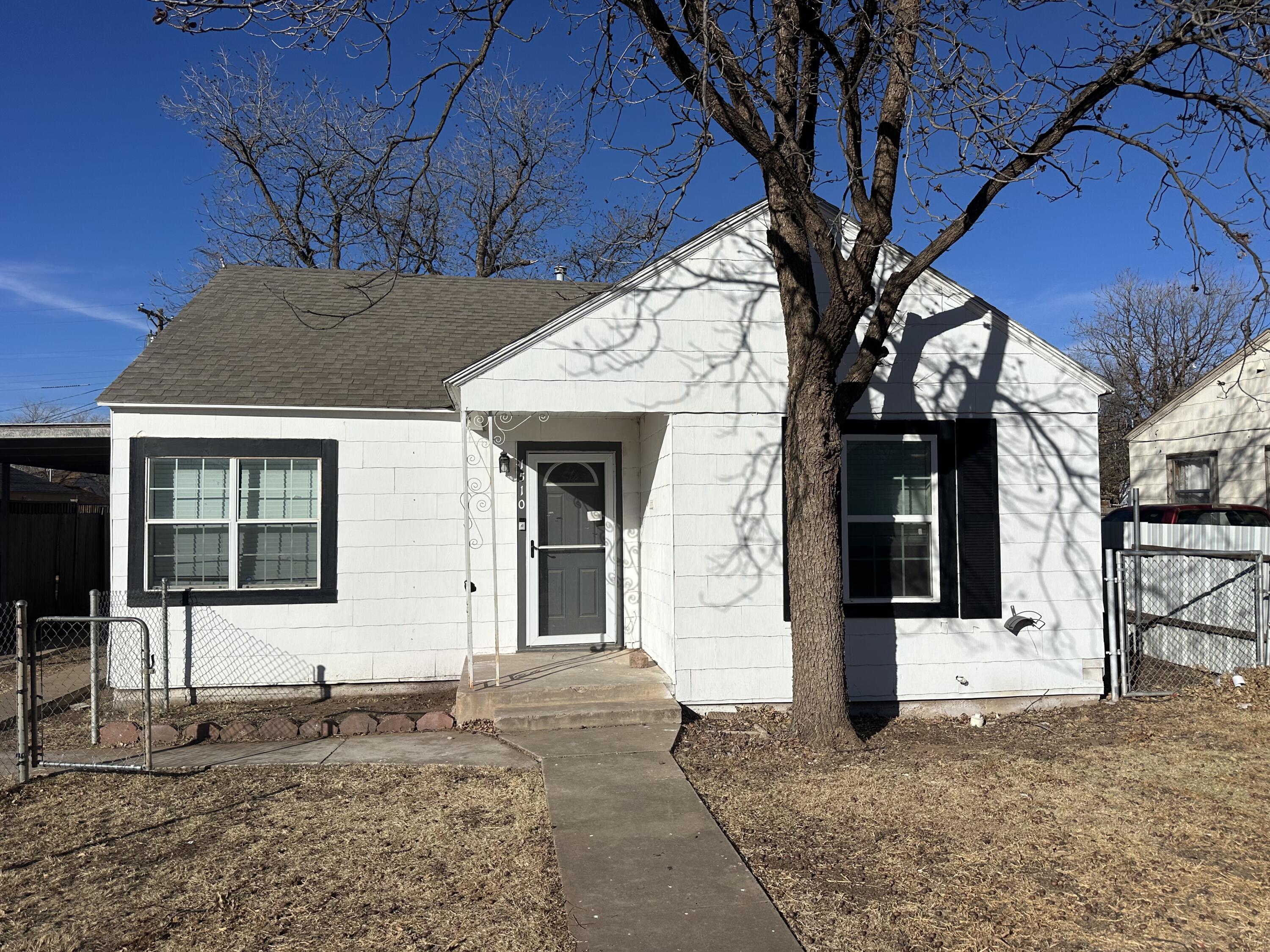 1510 28th Street Lubbock, TX 79411 - Photo 1 of 46 a front view of a house with a yard