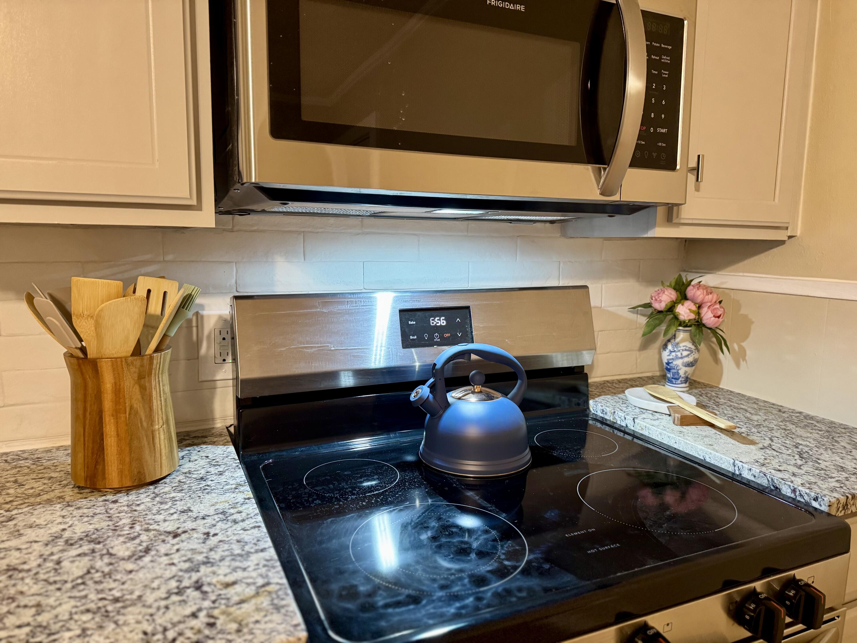 1510 28th Street Lubbock, TX 79411 - Photo 16 of 46 a kitchen with a stove and a microwave