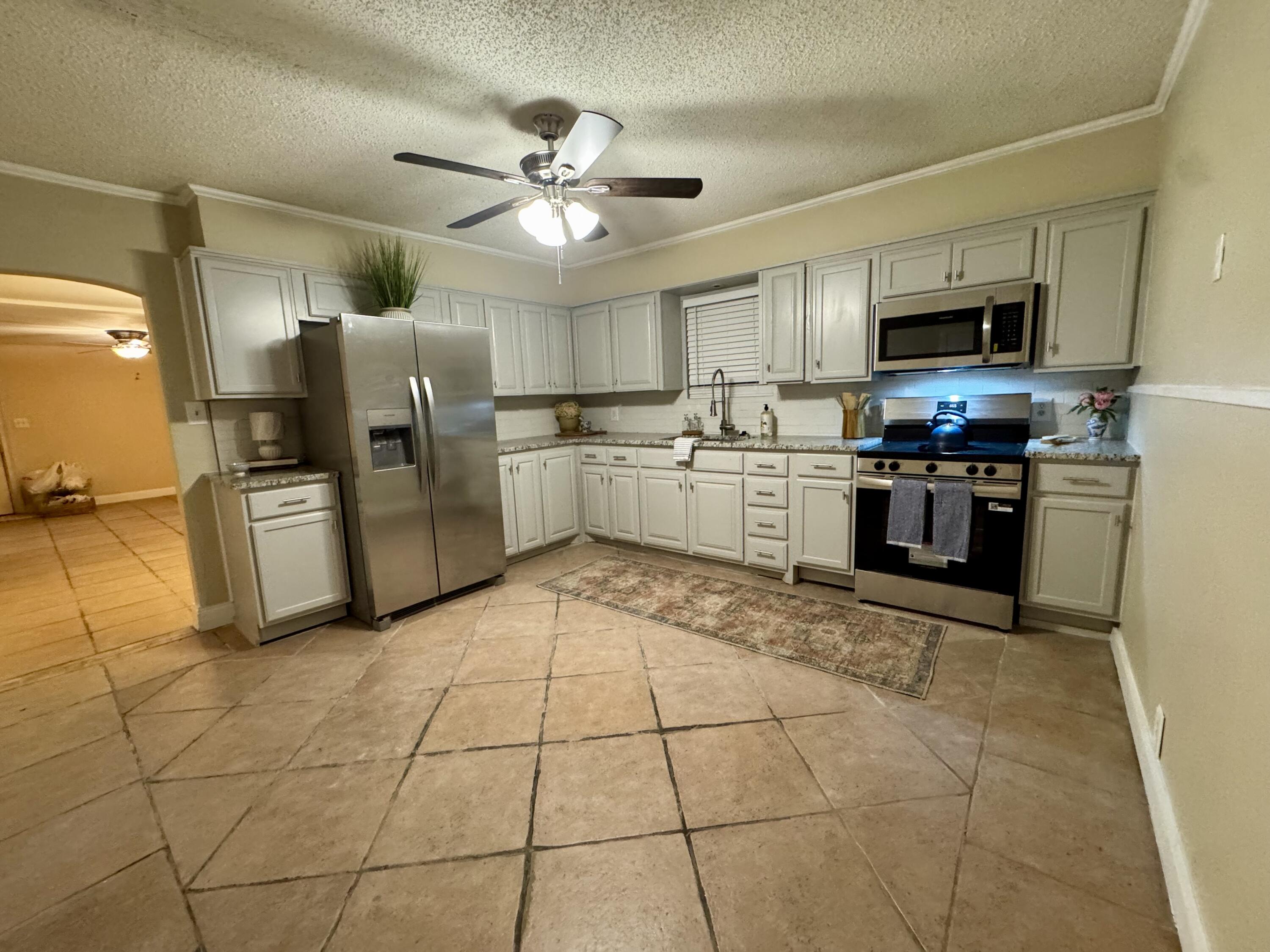 1510 28th Street Lubbock, TX 79411 - Photo 2 of 46 a kitchen with stainless steel appliances granite countertop a refrigerator and a sink