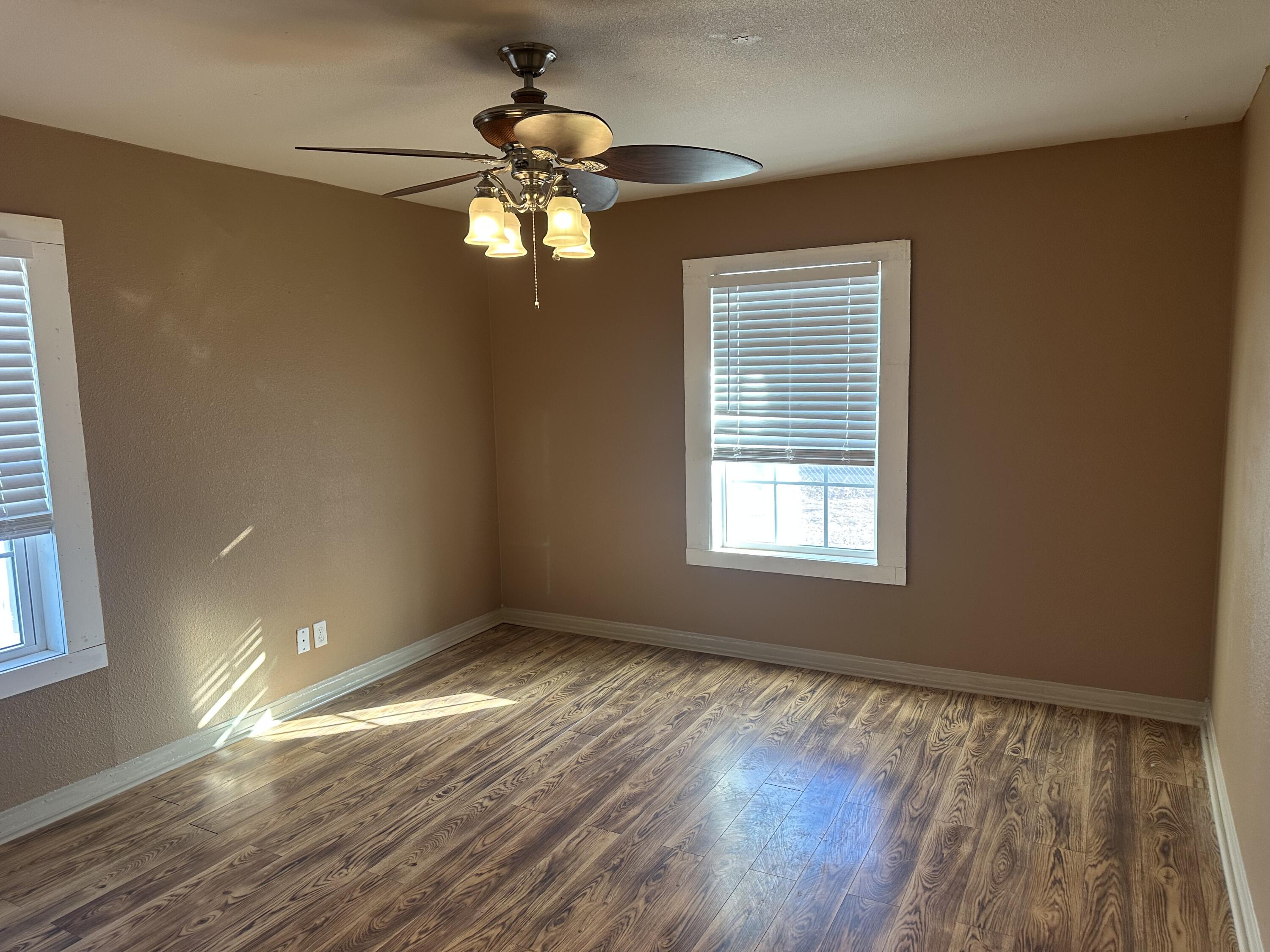 1510 28th Street Lubbock, TX 79411 - Photo 24 of 46 a view of an empty room with wooden floor and a window