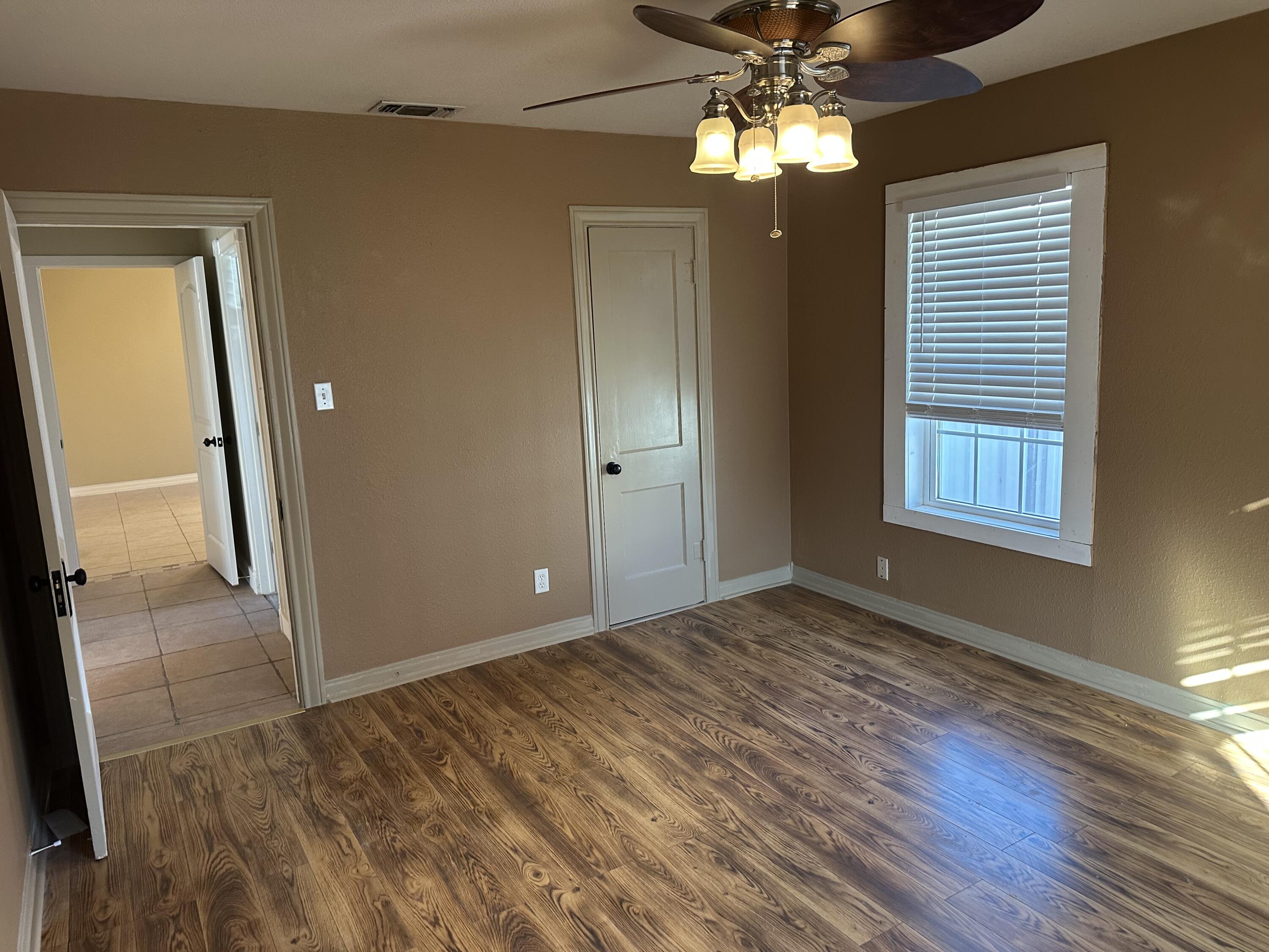 1510 28th Street Lubbock, TX 79411 - Photo 25 of 46 a view of empty room with wooden floor and fan