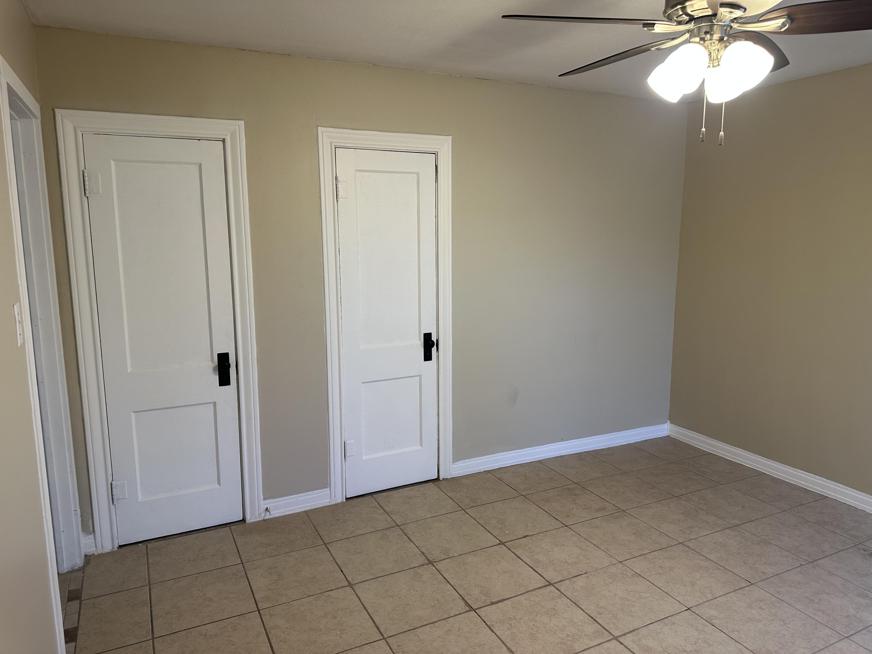 1510 28th Street Lubbock, TX 79411 - Photo 27 of 46 an empty room with a chandelier fan