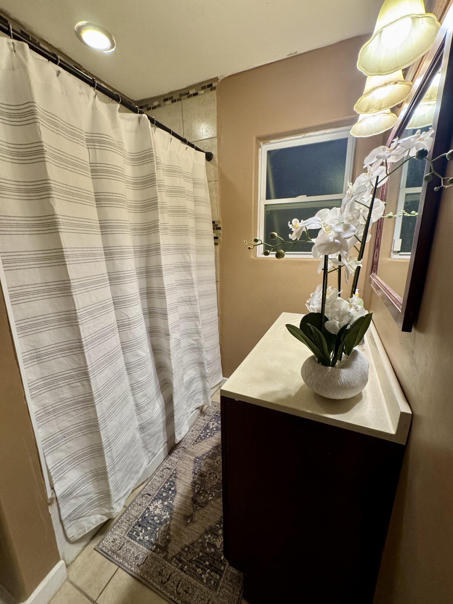 1510 28th Street Lubbock, TX 79411 - Photo 36 of 46 a bathroom with a sink and a mirror