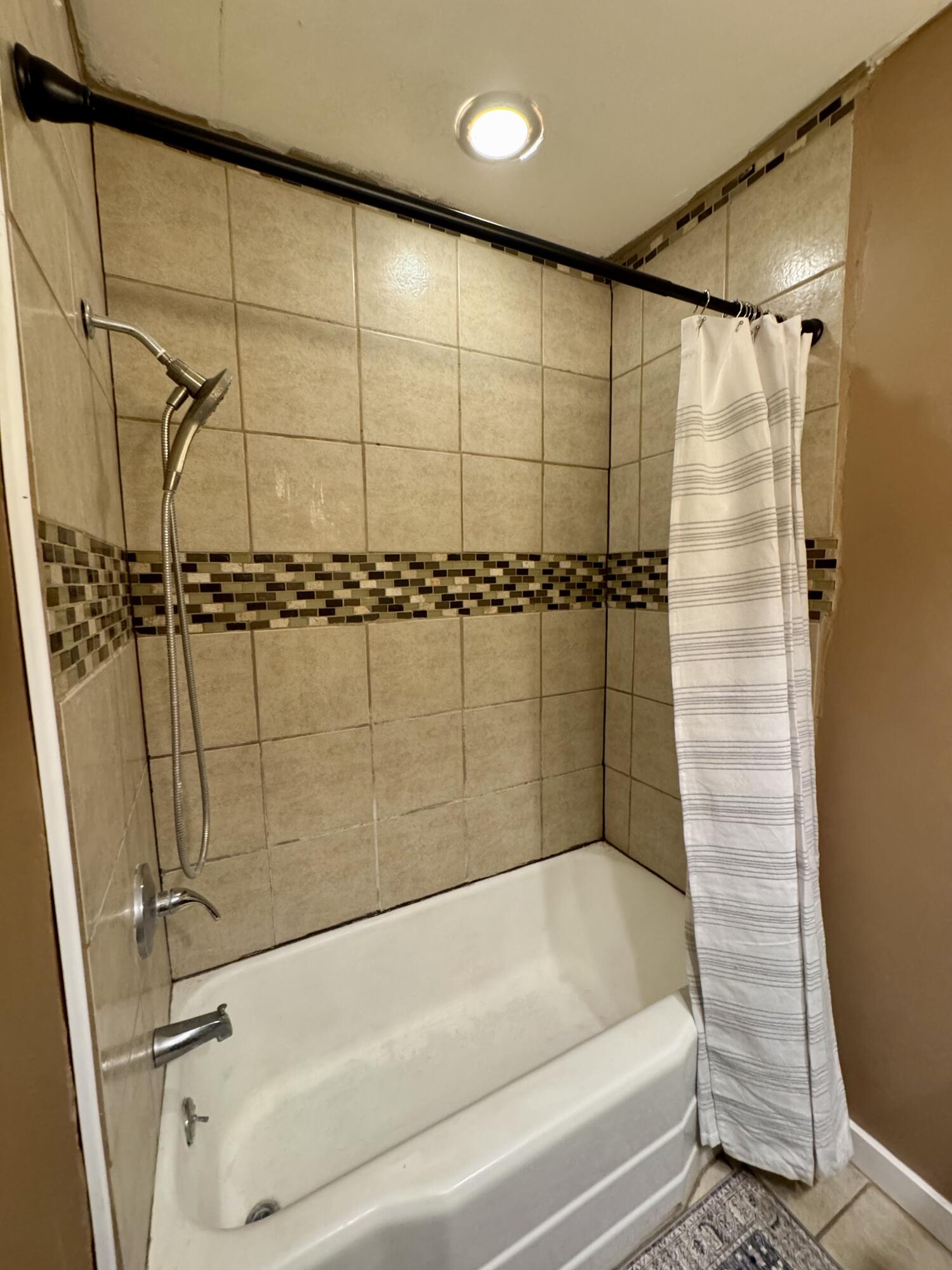 1510 28th Street Lubbock, TX 79411 - Photo 37 of 46 a bathroom with a shower and a bathtub