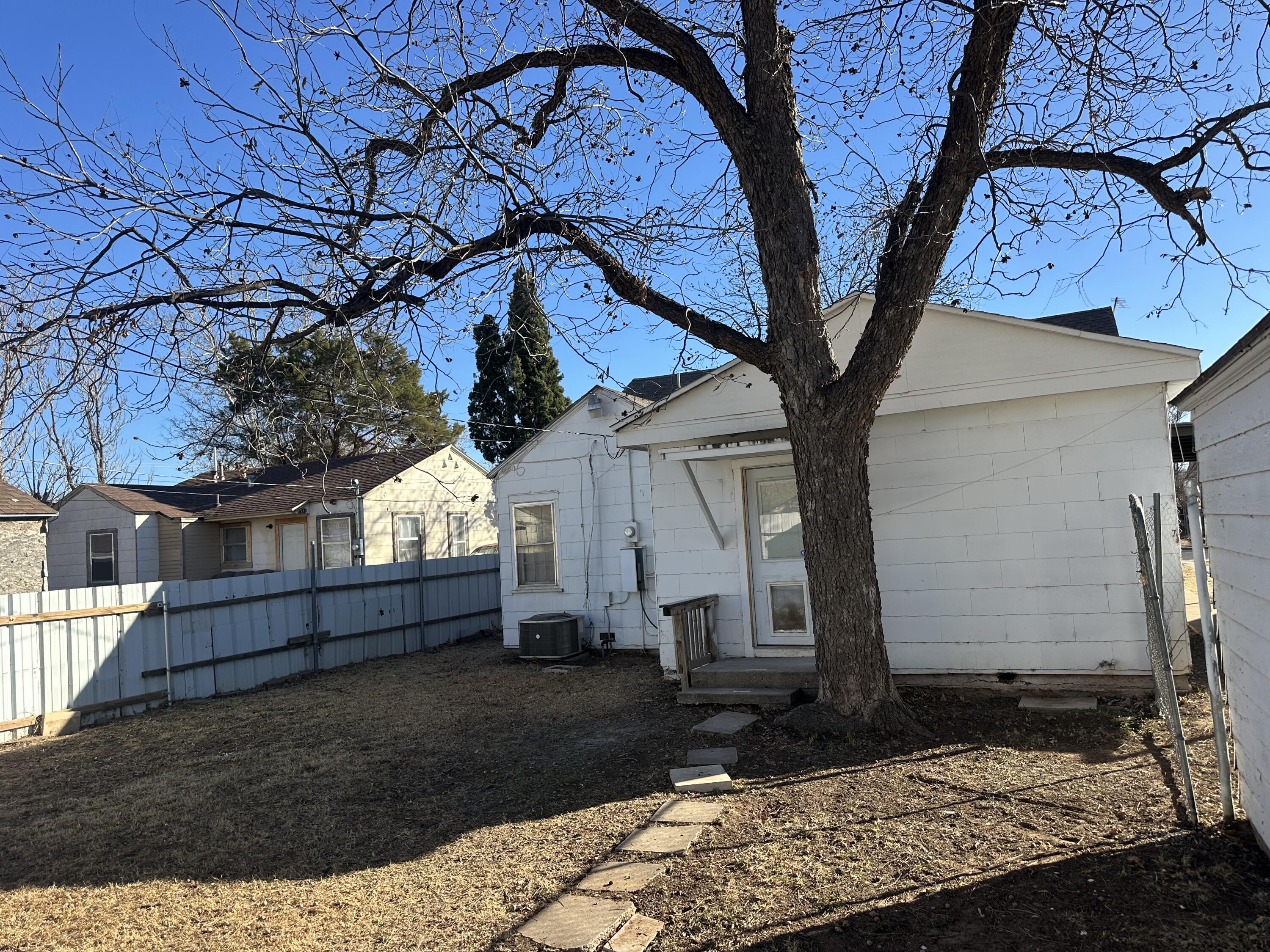 1510 28th Street Lubbock, TX 79411 - Photo 43 of 46 a view of a backyard with a tree